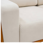 Close-up of a beige sofa with wooden legs on a white background