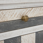 Wooden drawer with a brass handle on a distressed wood panel background