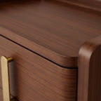 Close-up of a wooden drawer with a gold handle