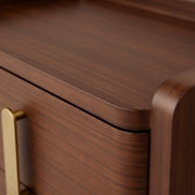 Close-up of a wooden drawer with a gold handle
