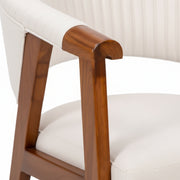 Chair with wooden armrests and white cushioned seat on a neutral background