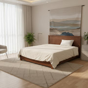 Modern bedroom with wooden bed, white bedding, and large wall art.