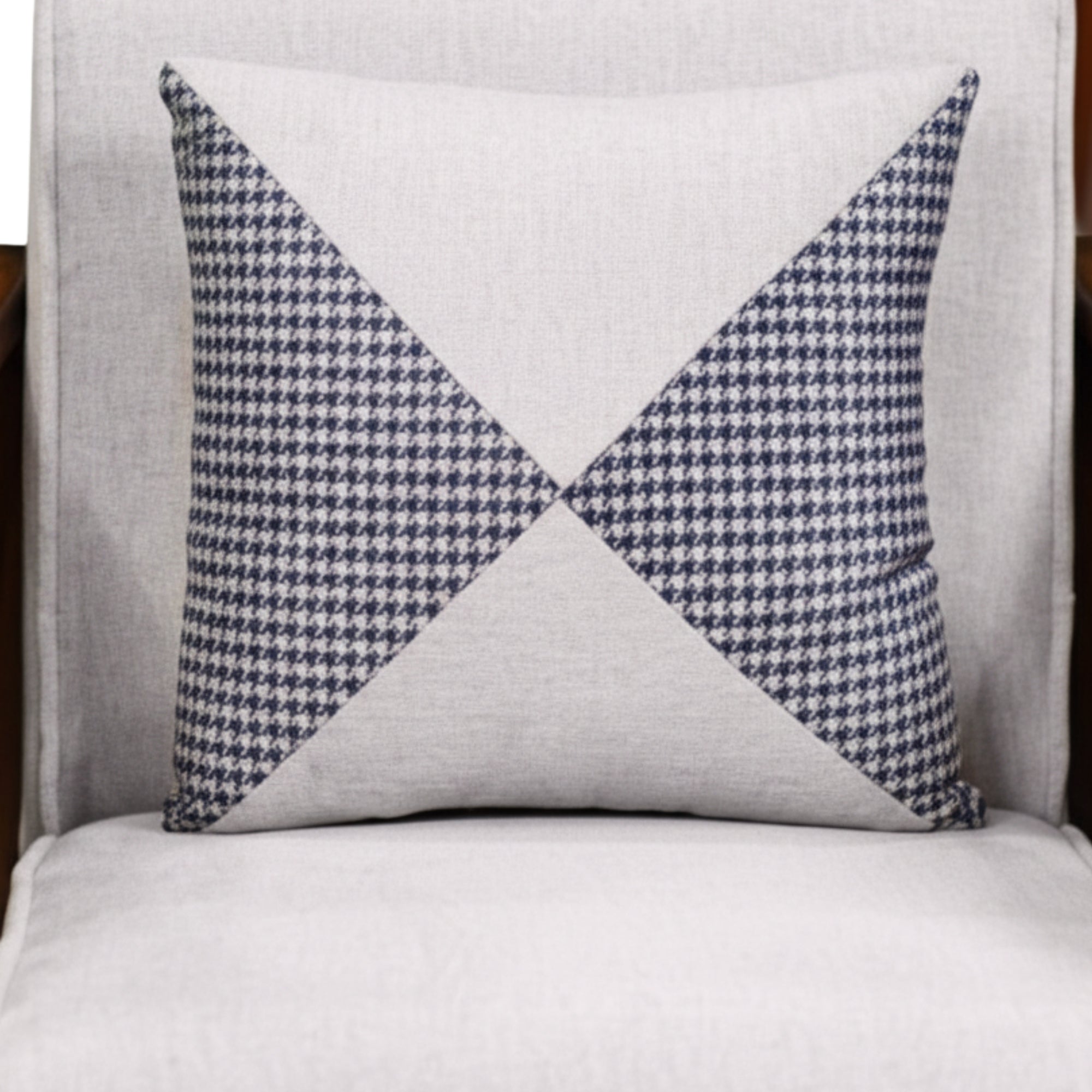 Decorative pillow with blue and white geometric pattern on a gray background