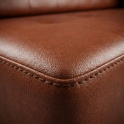 Close-up of brown leather texture with stitching details