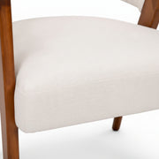Close-up of a chair with wooden legs and white cushioned seat on a white background