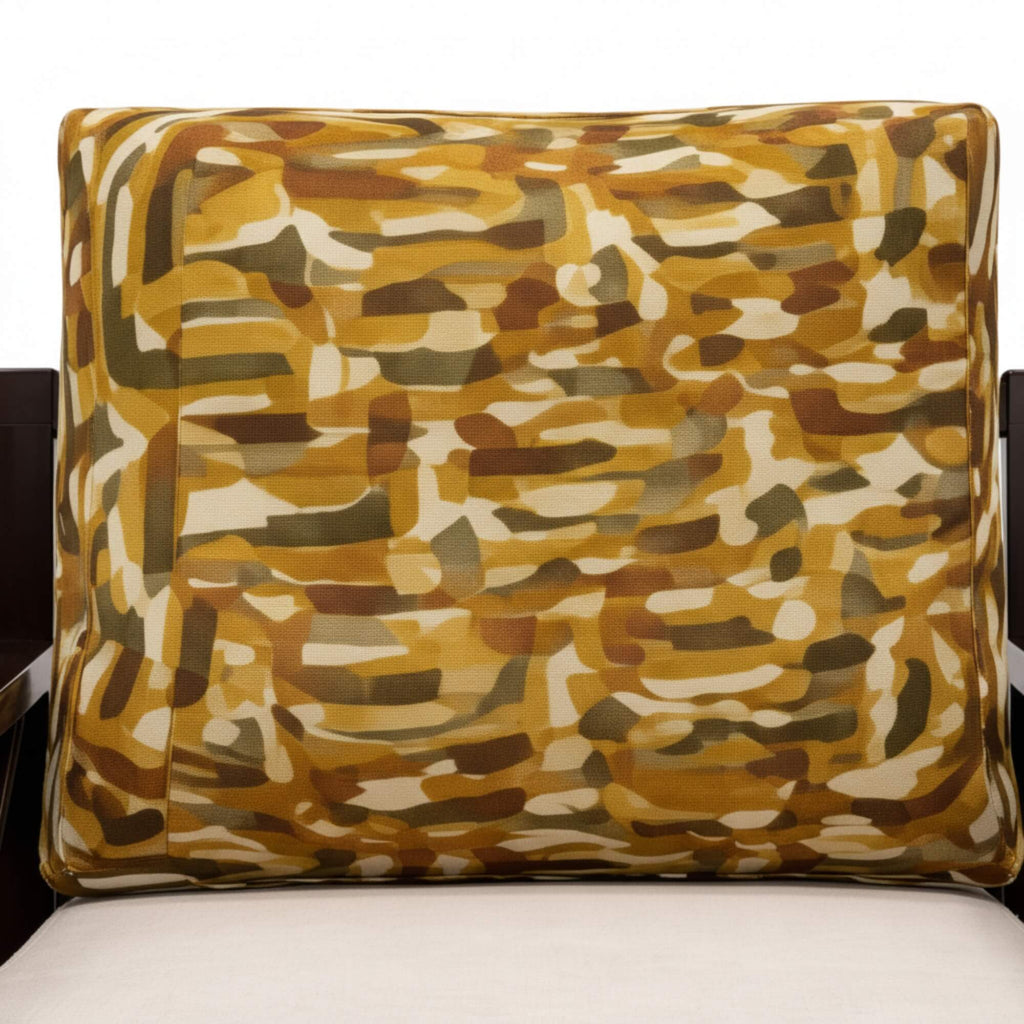 Camouflage-patterned pillow on a chair with a white background
