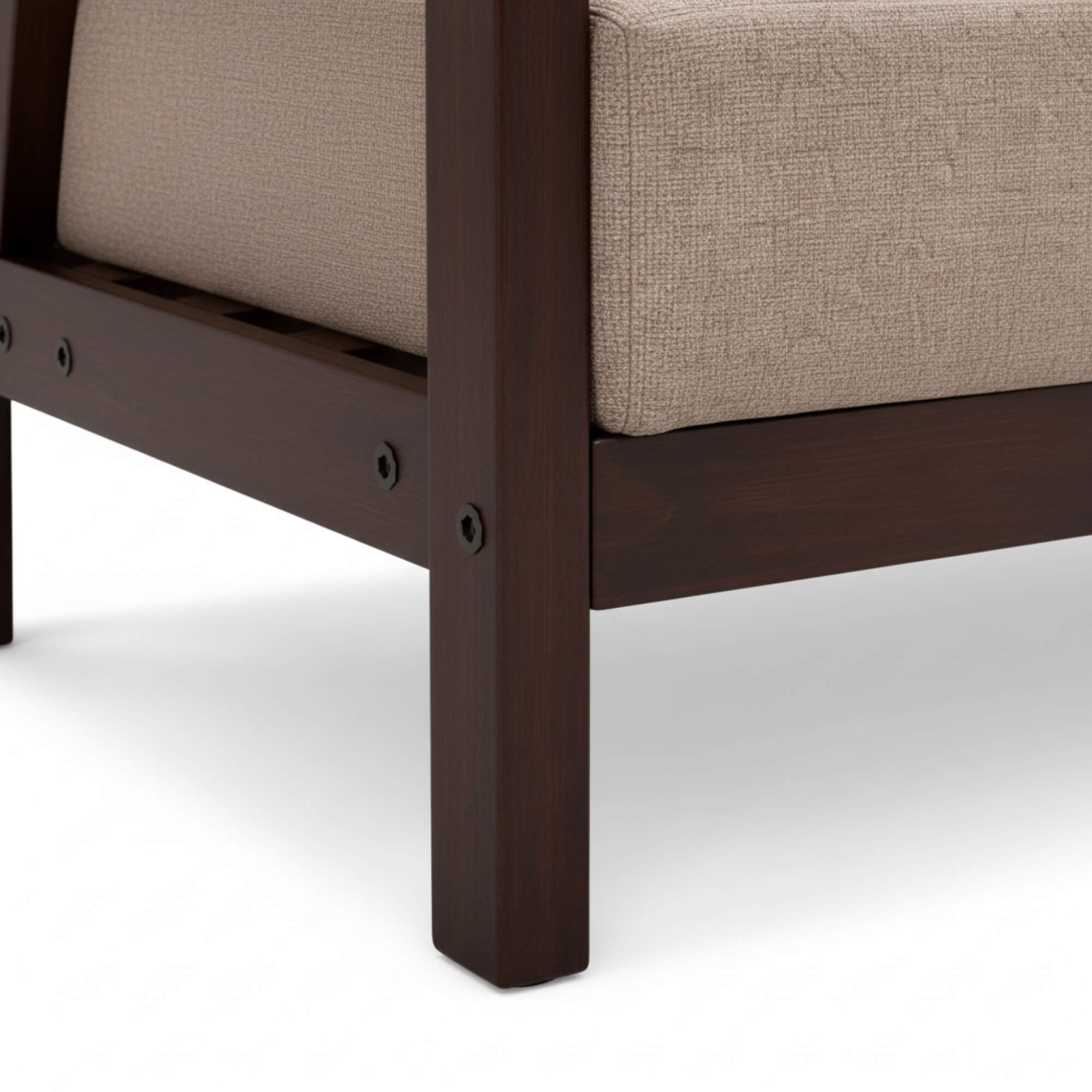 Close-up of a wooden chair leg with a beige cushion on a white background
