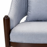 Gray cushioned chair with wooden armrest on a white background