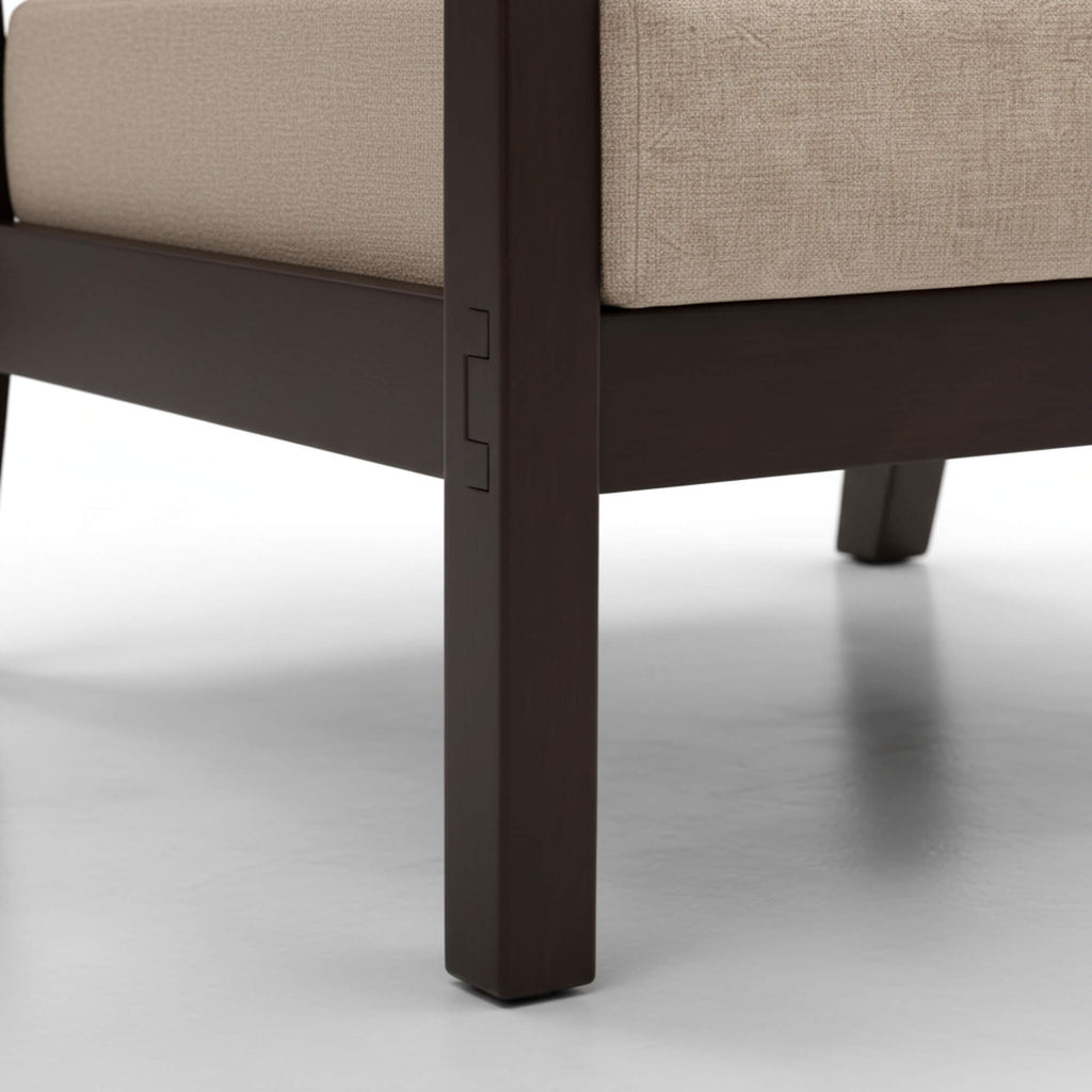 Close-up of a chair leg with a beige cushion on a white background