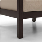 Close-up of a chair leg with a beige cushion on a white background
