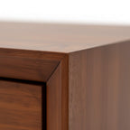 Close-up of a wooden cabinet corner with a neutral background