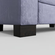 Gray upholstered furniture with dark wooden legs on a neutral background