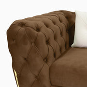 Brown tufted sofa with a white pillow
