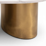Oval Marble Coffee Table 821’s texture, curved shape and brushed finish of one of the metallic gold pillar legs are showcased.